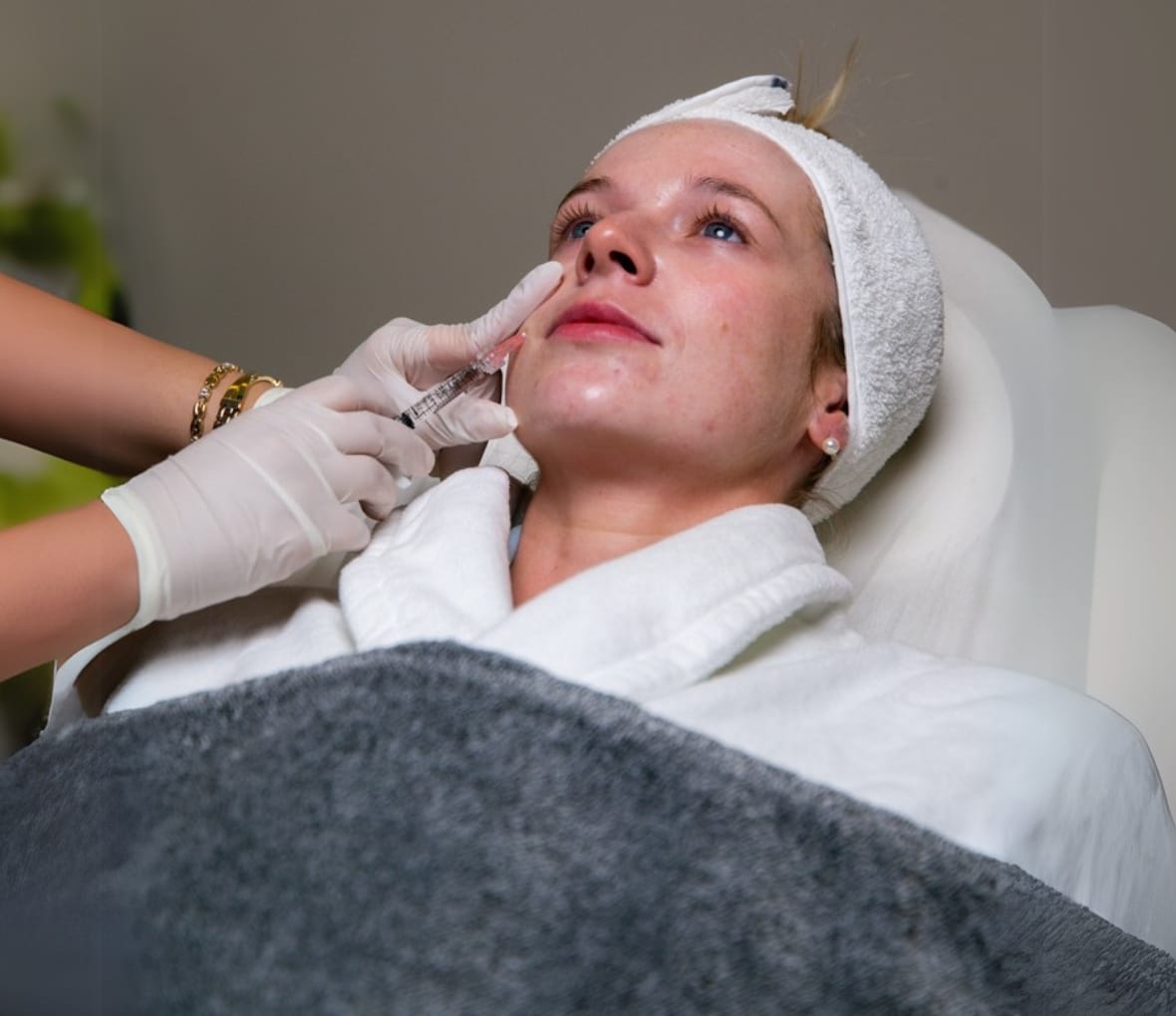 a girl is taking botox